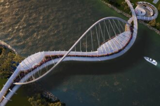 Aerial view of Mode’s Bougainvillea Bridge concept, connecting Toowong to West End with a sculptural, flower-wrapped pedestrian and cycle link.
