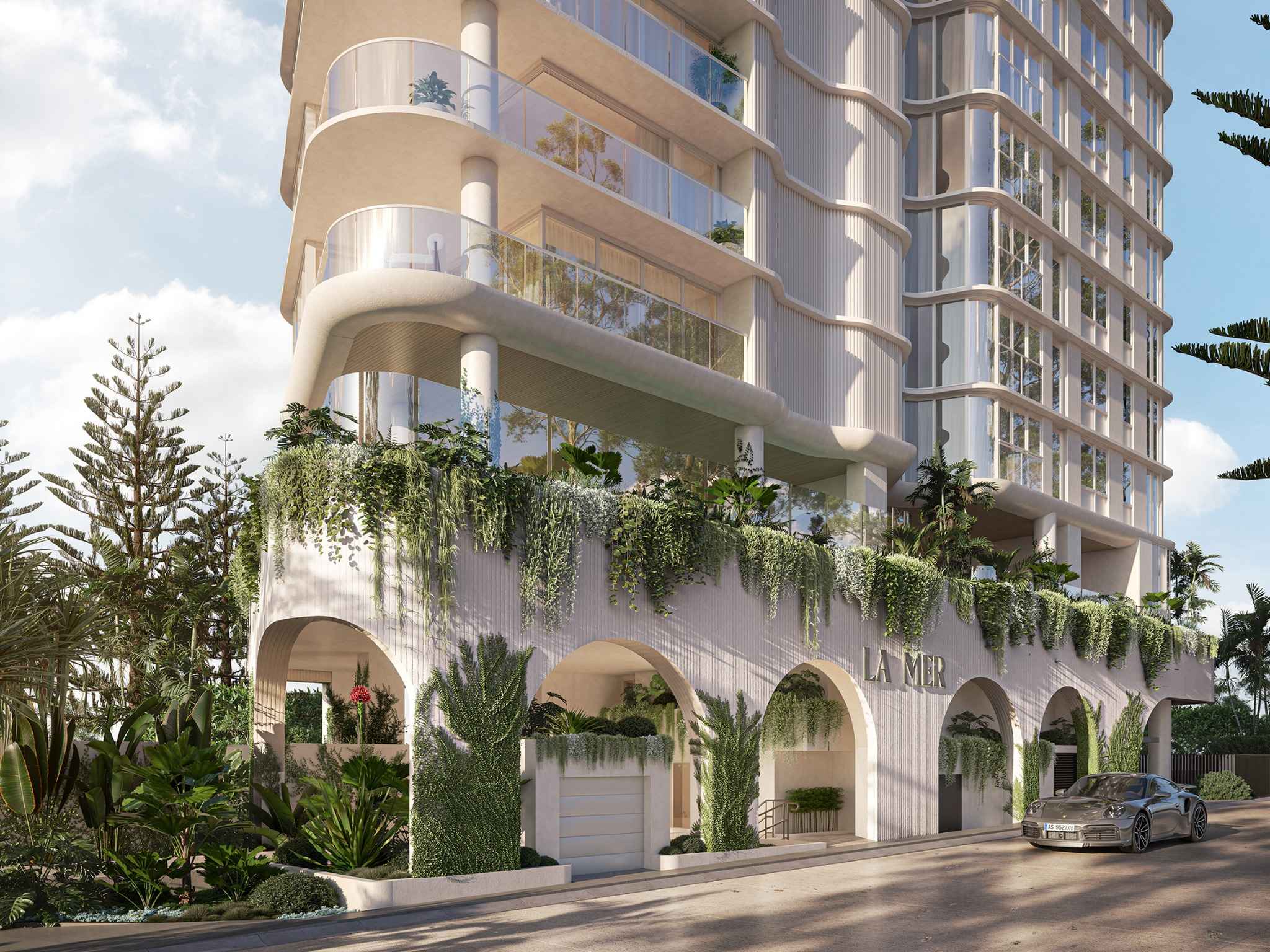 Street-level perspective of La Mer at 3580 Main Beach Parade, showing curved glass forms and coastal-inspired design.