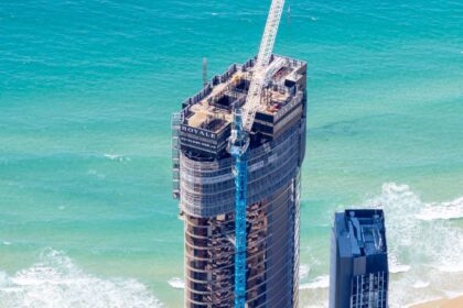Aerial photograph of Royale Gold Coast viewed from the west, highlighting progress on upper-level construction and proximity to the beachfront.
