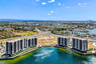 Aerial photograph of the Lanes residential buildings and surrounding lake system at Mermaid Waters.