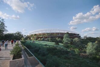 Architectural rendering of the Brisbane Stadium exterior showing terraced landscaping and shaded circulation spaces.
