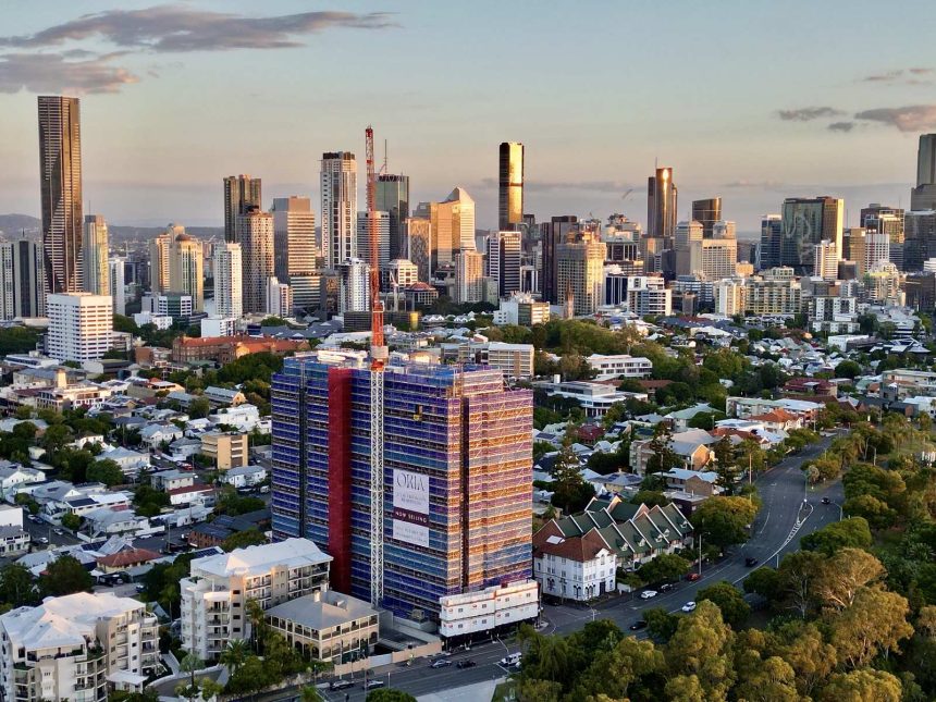 The topped-out Oria tower stands 15 storeys above Spring Hill, framed against the Brisbane CBD. Image supplied by Keylin.